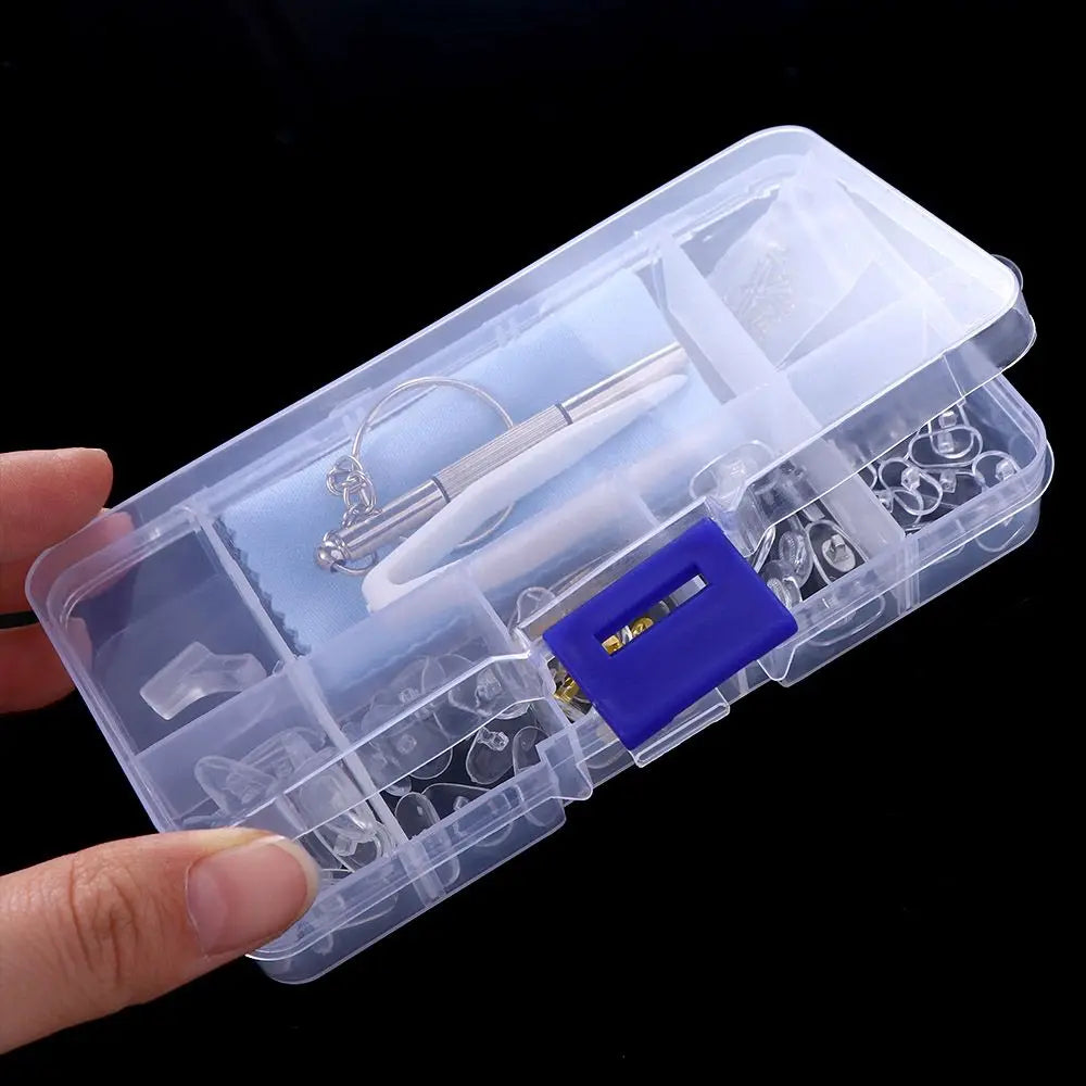 A clear plastic case containing a complete glasses repair kit with nose pads, screws, and precision tools.