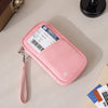 Pink RFID-blocking passport holder with a strap, placed on a light surface.