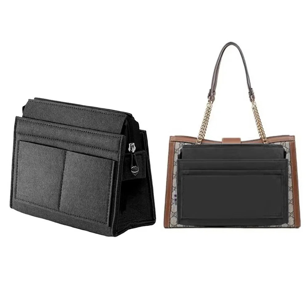 A black felt multi-pocket purse organizer insert with a leather strap and gold chain detail.