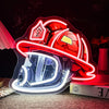 A red firefighter helmet neon sign with a clear visor and emblem, illuminated against a dark background.