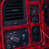 Close-up of a red patterned switch panel for a headlight and fog light system.