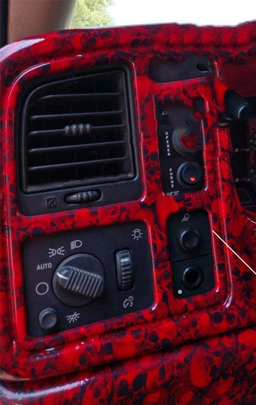 Close-up of a red patterned switch panel for a headlight and fog light system.