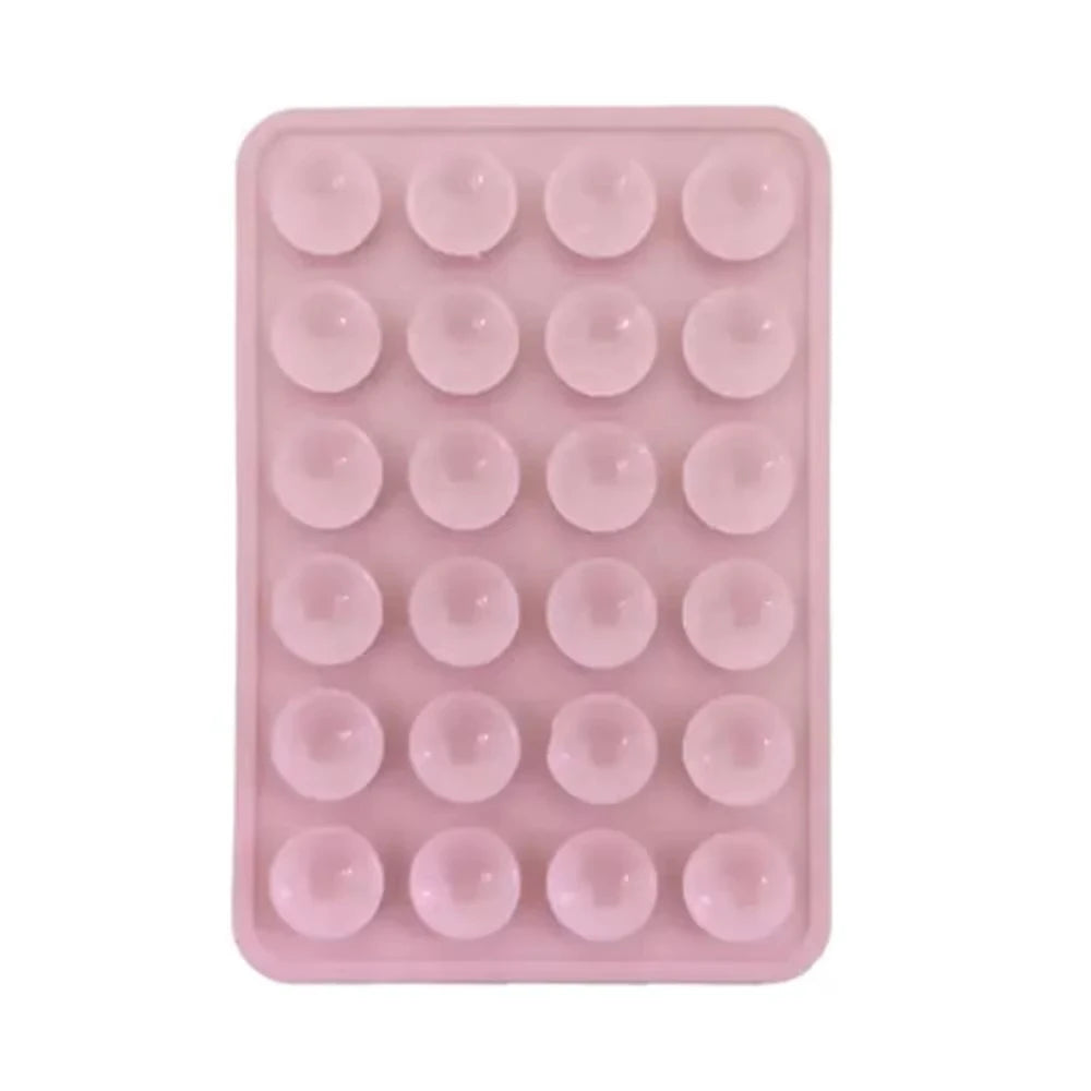 A pink reusable silicone suction cup phone mount with multiple suction cups for hands-free viewing.