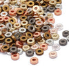 A close-up view of small round acrylic spacer beads in various gold and silver colors for jewelry making