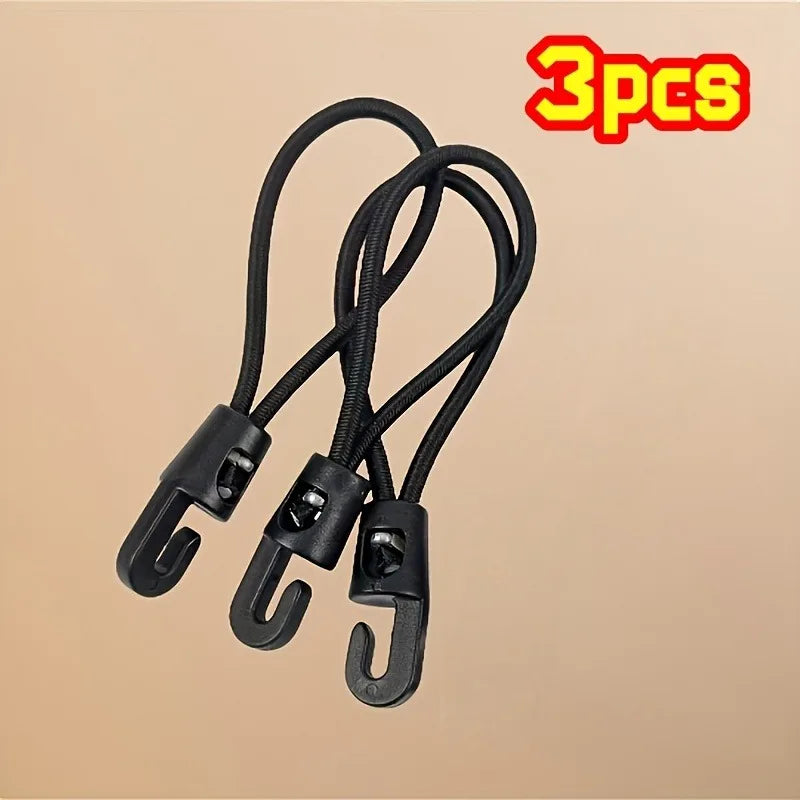Three black heavy-duty elastic tie-down straps with hooks displayed against a beige background.