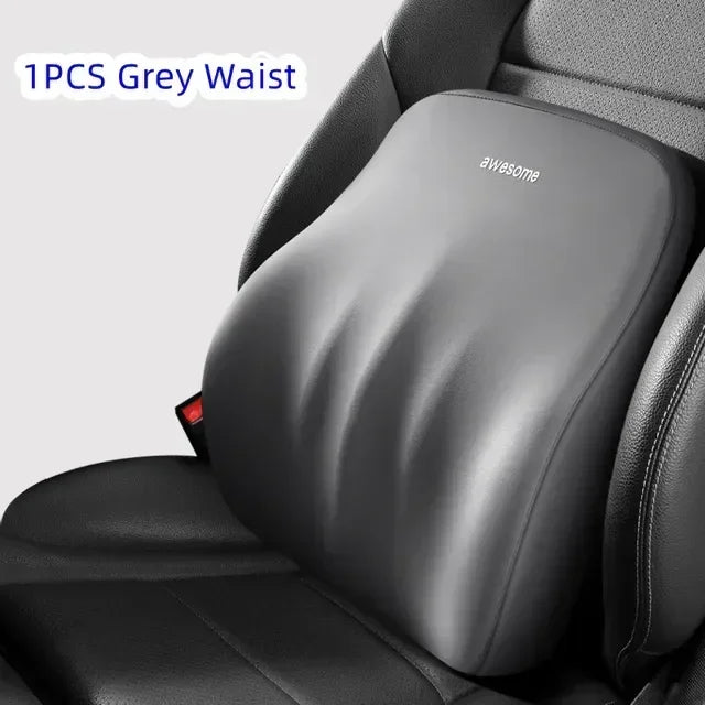 A grey waist pillow is shown placed on a black car seat headrest.