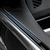 Close-up of a car side window featuring blue wiper strips for clear vision in the rain.