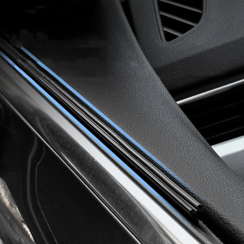 Close-up of a car side window featuring blue wiper strips for clear vision in the rain.