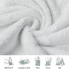 A soft white blanket is tightly rolled, showing its fluffy texture and drape.
