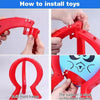 Hands demonstrate how to install toys into a red plastic frame for a party game.
