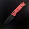 An orange folding pocket knife with a drop point blade shown against a black background.