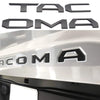 Black 3D letter emblem for a Toyota Tacoma tailgate featuring the word TACOMA