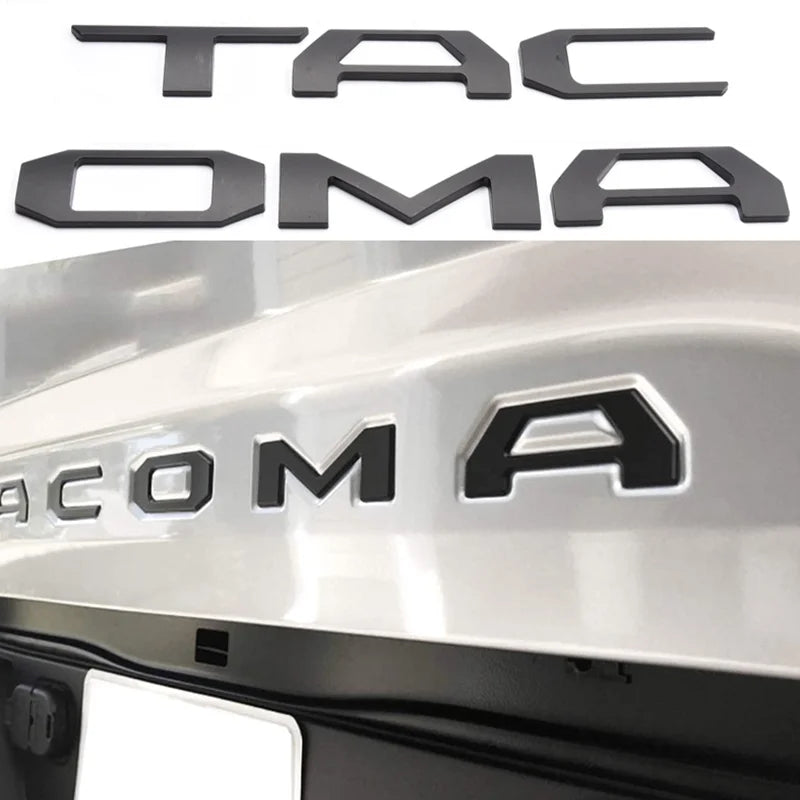 Black 3D letter emblem for a Toyota Tacoma tailgate featuring the word TACOMA