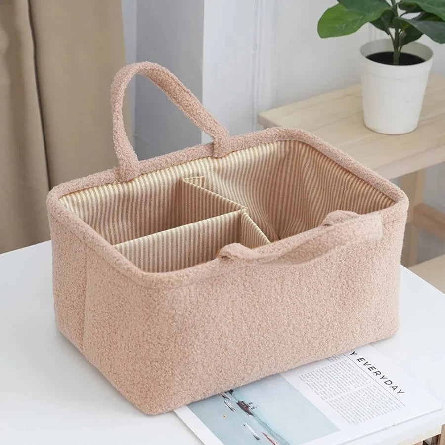 A beige portable diaper bag organizer with bottle storage is shown on a white table.
