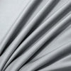 A close-up of a light gray luxury bamboo flat sheet draped softly, showing its silky texture and folds.
