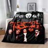 A black and white graphic blanket featuring members of the My Chemical Romance band.