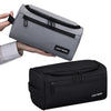 A gray and black travel toiletry bag is shown being held by a hand, with a black version displayed separately.