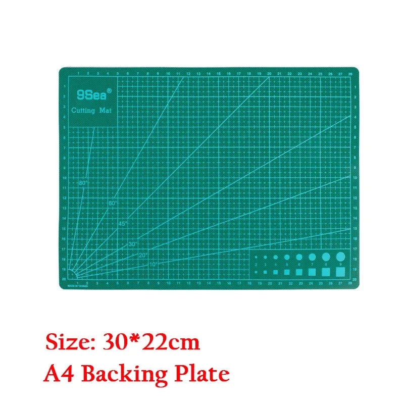A green 9Sea cutting mat with a grid and ruler markings for sewing and crafting.