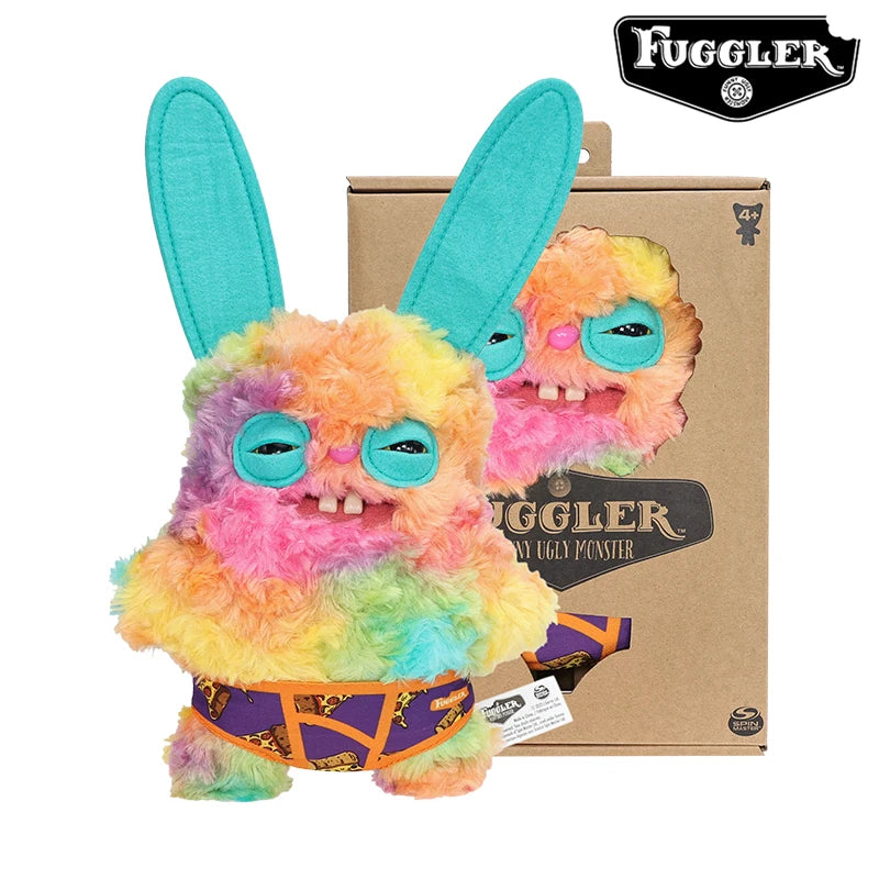 A fluffy, multi-colored plush toy monster with large blue eyes and funny teeth is shown next to its packaging box.