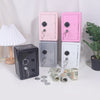 Three pink and silver vintage metal piggy banks with combination locks and keys displayed on a white surface.