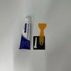 Tube of white wall repair paste with an orange scraper and a white piece of sandpaper.