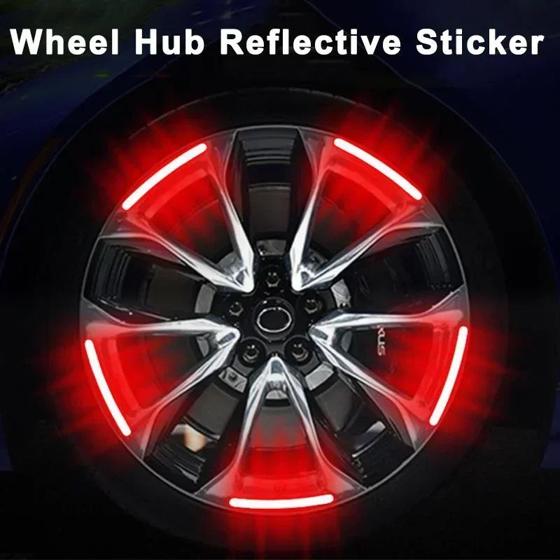 A close-up view of a car wheel hub with a bright red reflective sticker applied to the center cap.