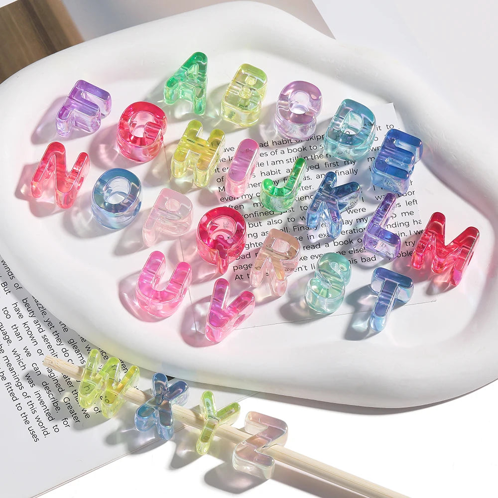 A collection of colorful acrylic alphabet beads in various shades and shapes arranged on a white plate.