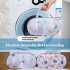 A white washing machine with a mesh laundry bag and two additional mesh laundry bags for bra removal