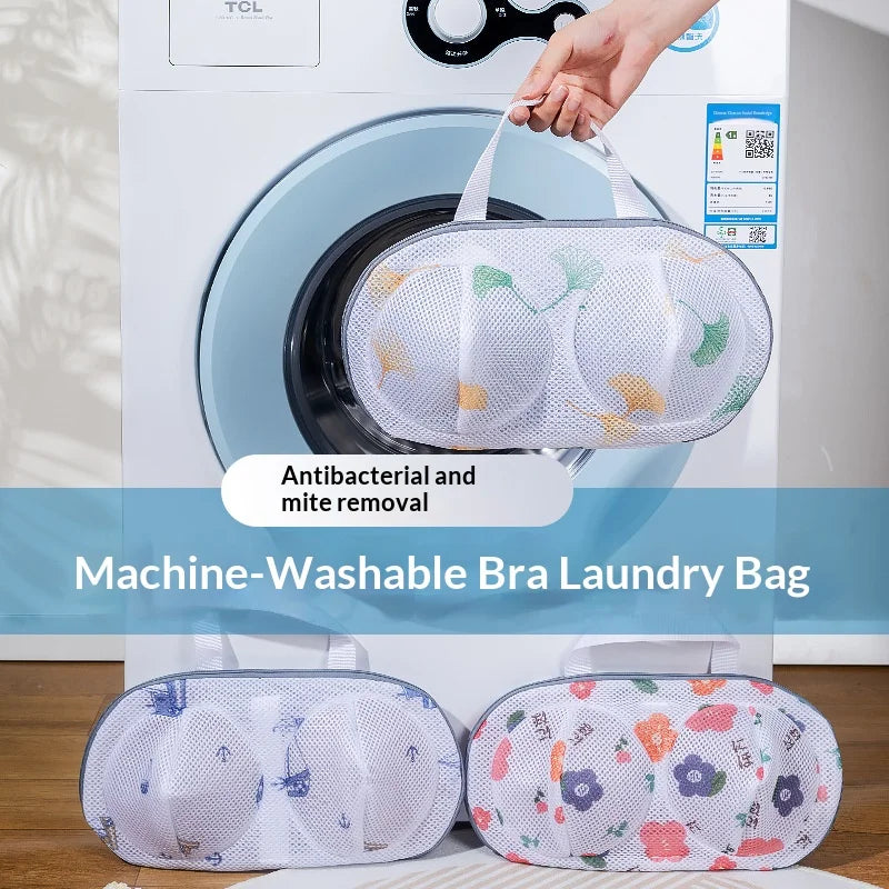 A white washing machine with a mesh laundry bag and two additional mesh laundry bags for bra removal