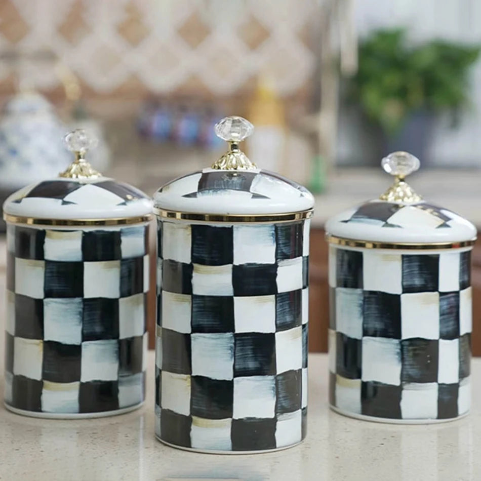 Three white and black checkerboard porcelain storage jars for tea, coffee, and sugar