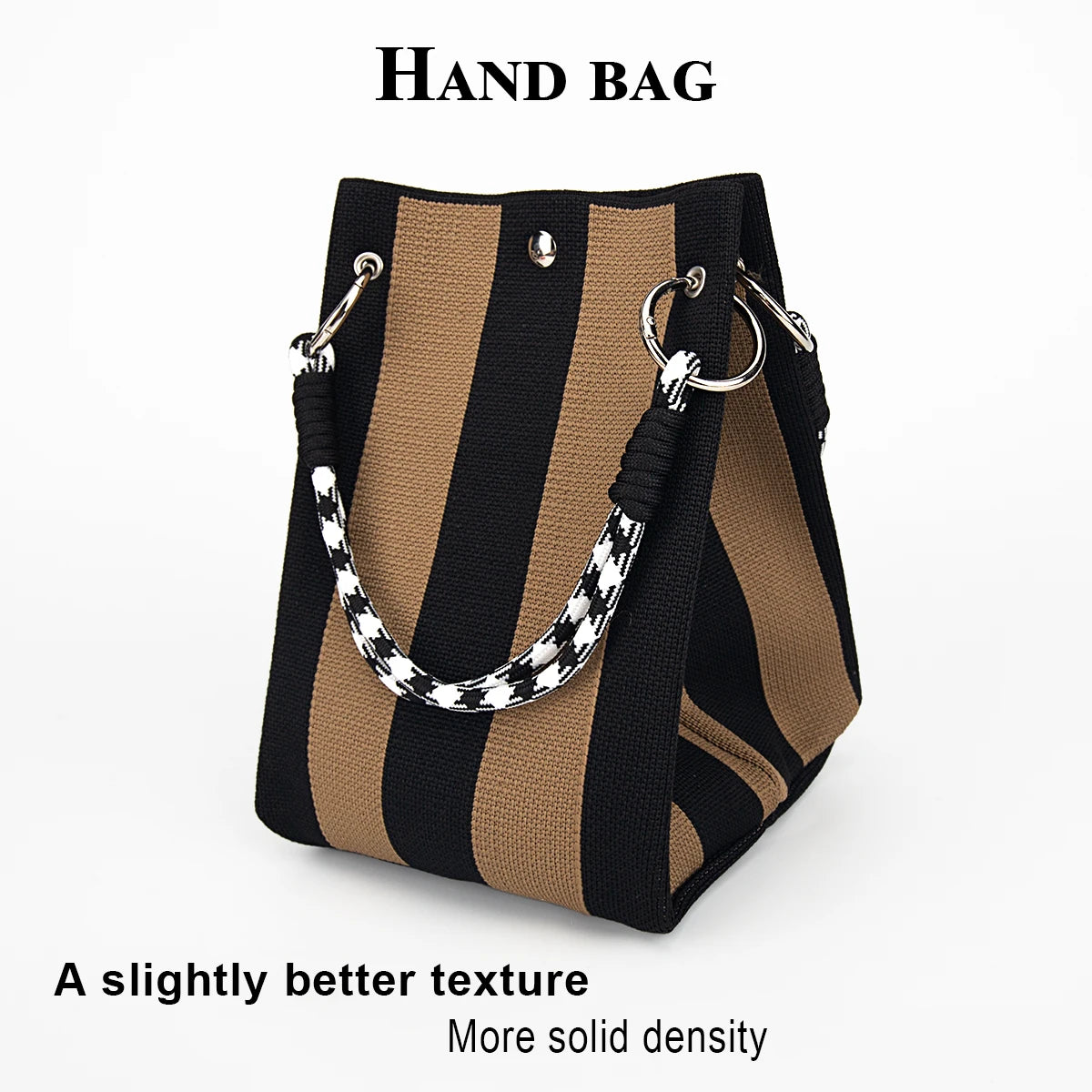 A hand bag featuring black and tan vertical stripes with a black and white patterned strap.
