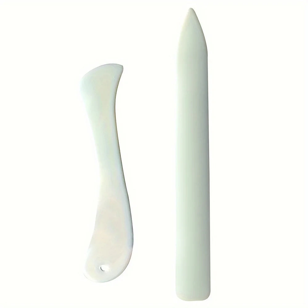 A white plastic bone folder and crease marker set for paper and leather crafts.