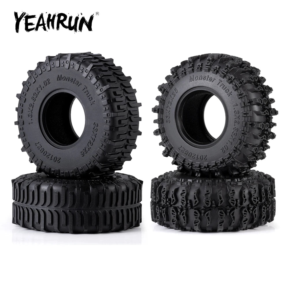 A set of four black monster truck mud terrain rubber tires for RC crawlers.