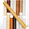 A close-up view of various rolls of self-adhesive wood grain waterproof wallpaper in different natural wood tones.