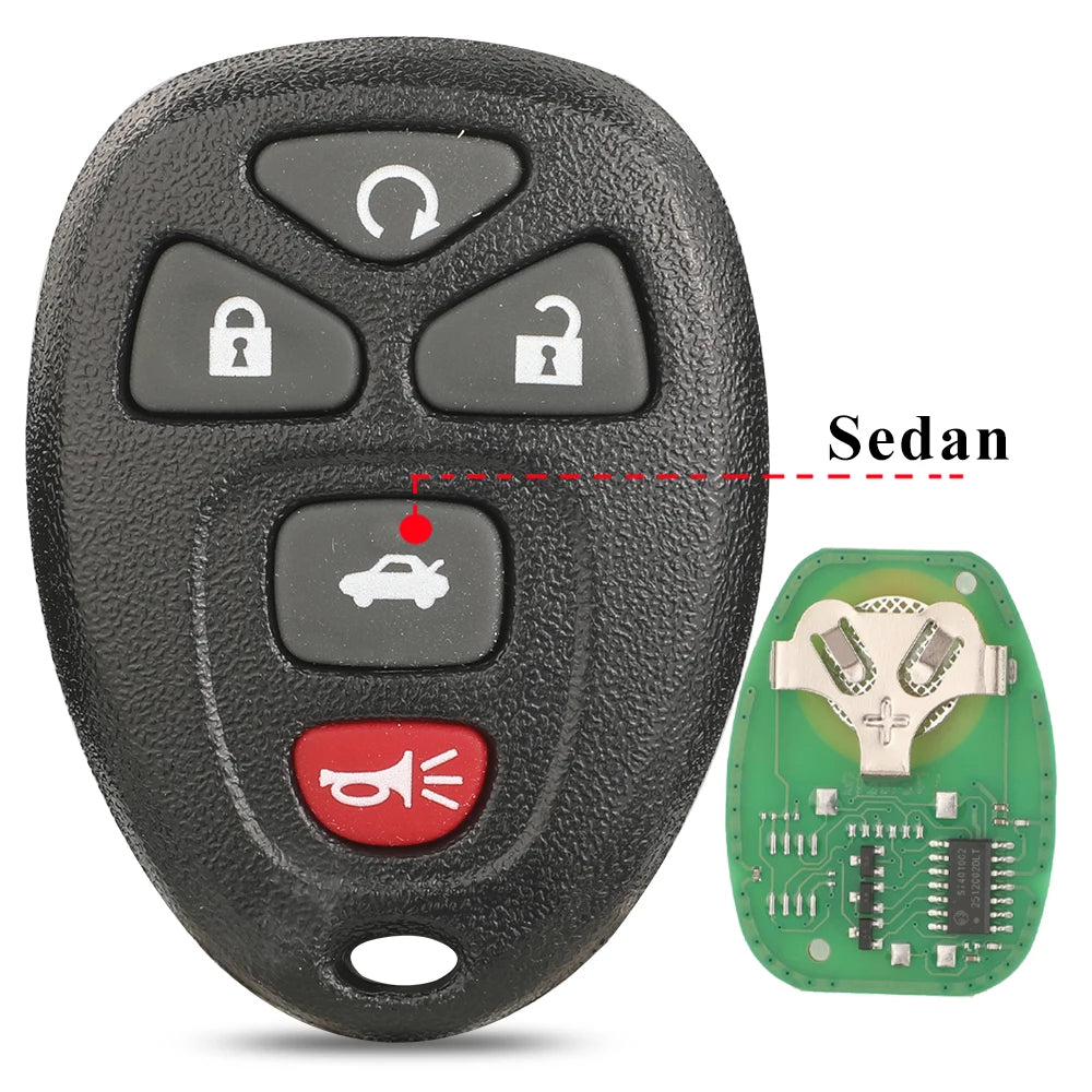 A black car key fob with buttons and a red indicator, next to a green circuit board.