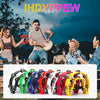 A variety of half-moon tambourines with double row metal jingles in various colors are displayed outdoors.