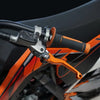 Close-up of an orange and black dirt bike handlebar featuring a CNC aluminum brake and clutch lever set.