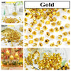 A collection of shiny gold acrylic crushed ice gems used for vase fillers and decor.