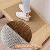 A faux sisal non-slip kitchen runner rug is shown on a light wood table, with a person's foot resting on it.
