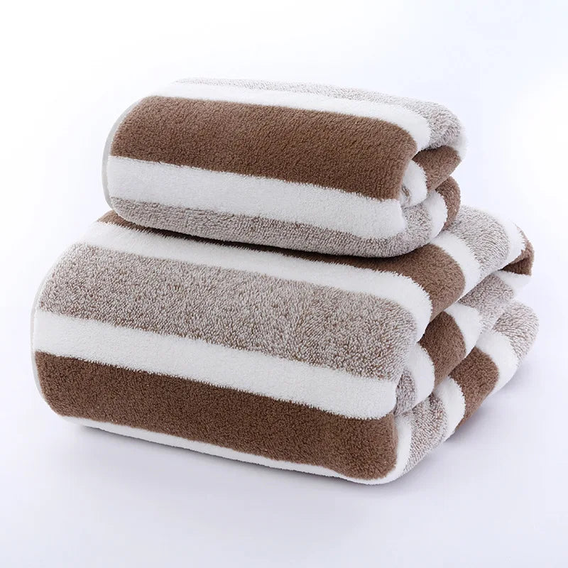 A stack of striped microfiber towels in brown and white are shown.