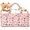 A pink floral diaper organizer bag featuring a teddy bear charm and multiple compartments for baby supplies.