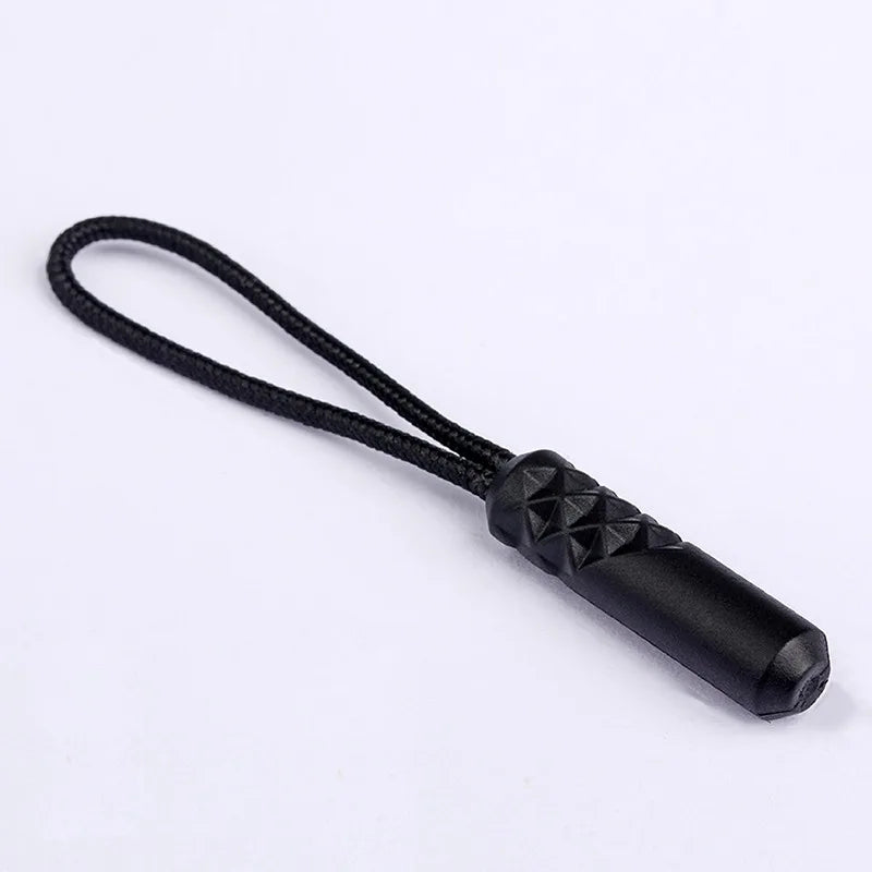 Black replacement zipper pull with a nylon cord and textured end.