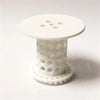 White flexible hair catcher drain cover with multiple holes and a circular base.