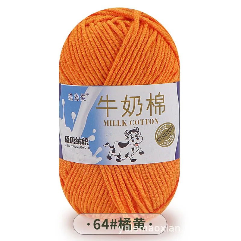 A ball of bright orange milk cotton blend yarn labeled for knitting and crochet projects.