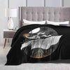 A black blanket featuring a silhouette of a white dragon against a moonlit background.