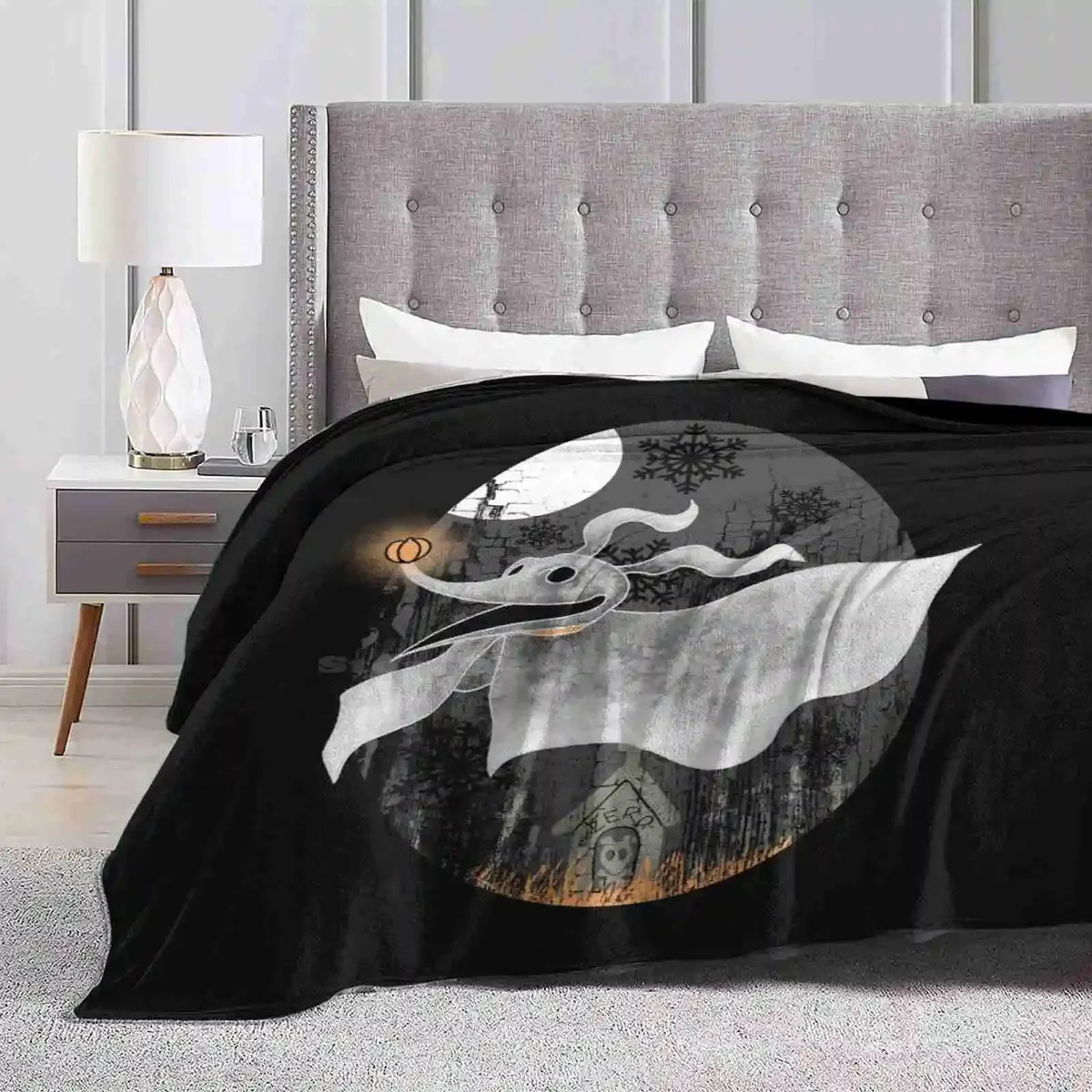 A black blanket featuring a silhouette of a white dragon against a moonlit background.