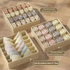 A collection of fabric organizers and drawers made from folded fabric, including pink, white, and purple items.