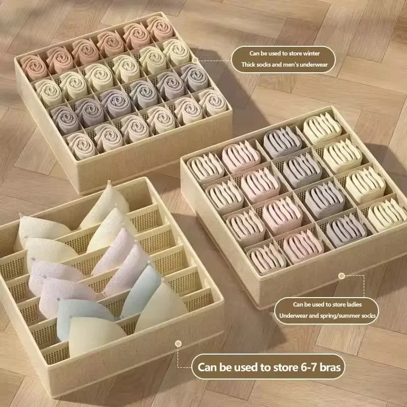 A collection of fabric organizers and drawers made from folded fabric, including pink, white, and purple items.