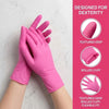 Pink disposable nitrile gloves shown on a hand, highlighting features like textured grip and rolled cuff.