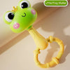 A bright green frog shaker toy with large eyes and a yellow ring is shown against a light background.